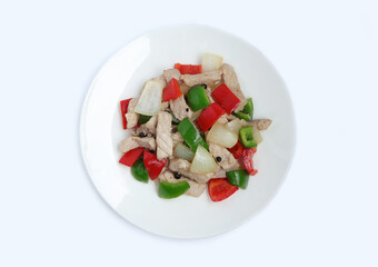 Stir fried pork with sweet peppers, onion and black pepper on white dish. Top view ,white background.