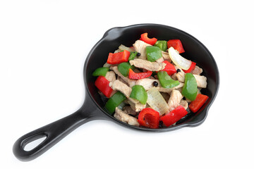 Delicious Stir fried pork with sweet peppers, onion and black pepper on black pan. Top view.