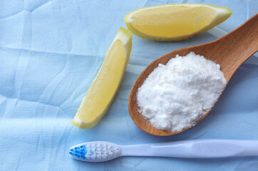 Baking soda (sodium bicarbonate), Fresh sliced lemon and toothbrush on the table.Home cleaning concept.