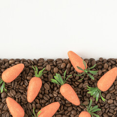 Trendy composition with easter carrot made and coffee roasted beans in pastel colors .Creative Realistic art, minimal aesthetic look. Contemporary style.Writing space, copy space ,top view. Flat lay