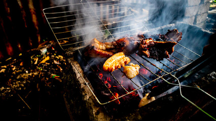 Pork is grilled on the coals
