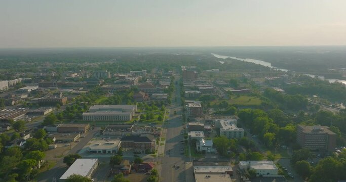 Aerial Forward Shot Of Residential Buildings In City By River, Drone Flying Forward Over Road On Sunny Day - Tuscaloosa, Alabama