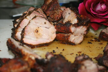 Tasty barrel roast pork decorated with red roses