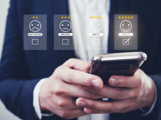 Customer review good rating concept hand pressing smile face icon and five star on visual screen for positive customer feedback, testimonial and testimony.