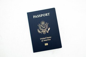 Close-up of a US passport with immigration, visa, citizenship, and travel paperwork on a wooden table