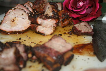 Tasty barrel roast pork decorated with red roses