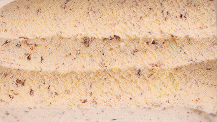 Close-up of the chocolate chip ice cream that marks the lap of the steel spoon.