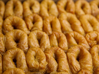 baklava rolls nest, oriental dessert made of phyllo, nuts, butter and syrup served on tray. Traditional turkish, arabic, jewish sweet. Full frame background, top view