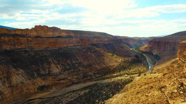 The Ghoufi canyon with the Abio river surrounded by palm trees and ruin.