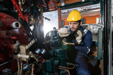 Portrait of Engineer train Inspect the train's diesel engine, railway track in depot of train