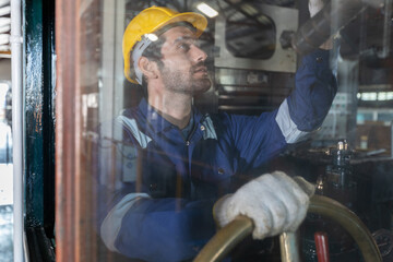 Portrait of Engineer train Inspect the train's diesel engine, railway track in depot of train