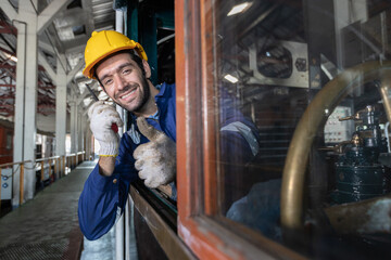 Portrait of Engineer train Inspect the train's diesel engine, railway track in depot of train