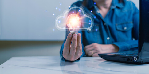 woman holding a brightly lit light bulb represents creativity and accessing big data on cloud computing.