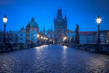 Fototapeta na wymiar Charles Bridge, Prague at dramatic evening, Czech Republic, with night lighting