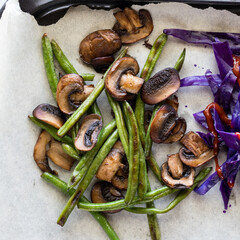 A mixture of sauteed beans and mushroom on parchment