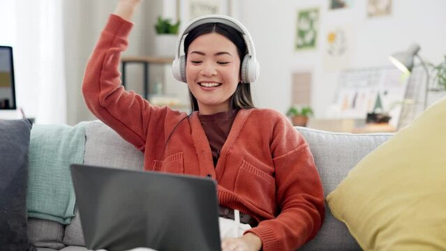 Happy woman, laptop or dancing to music headphones on house sofa, home couch or living room in fun energy or freedom. Smile, asian or dancer listening to radio, podcast or song on technology playlist