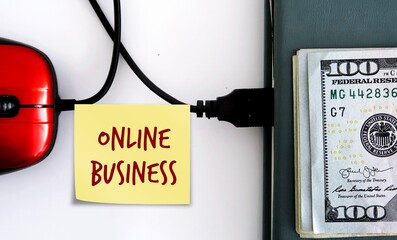 Red mouse connected with notebook and cash dollars money with note written ONLINE BUSINESS, concept of making money income from writing side job or build earnings from internet, online business owner