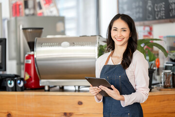 Coffee Business owner Concept - attractive young beautiful caucasian barista in apron holding...