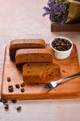 Homemade chocolate sponge cake or chiffon cake on white plate so soft and delicious with ingredients: eggs, flour, milk on wood table. Homemade bakery concept for background and wallpaper.