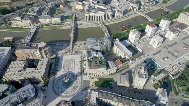 Aerial panoramic view of Skopje downtown with square, Alexander the Great monument and architecture along Vardar river with Stone and other bridges