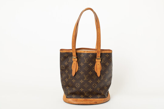 Foto de Kyiv, Ukraine. March 3, 2020. Louis Vuitton famous monogram.  Multicolored logo printed on knitted synthetic black fabric. Luxury brand  backgrounds and textures. French fashion house and retail company do Stock