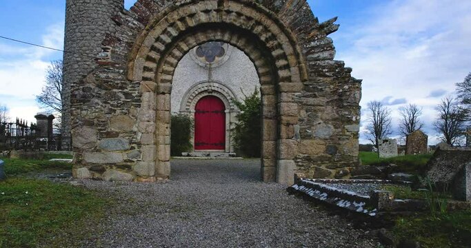 4 K Drone flight through the  stone arch entrance to Castledermot church and round tower Co Kildare Ireland dating to 800 AD