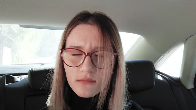 Angry young woman in backseat of a car being nervious and angry to her friend