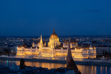 Obraz na płótnie Canvas Budapest parliament illuminated at night and Danube river, Hungary