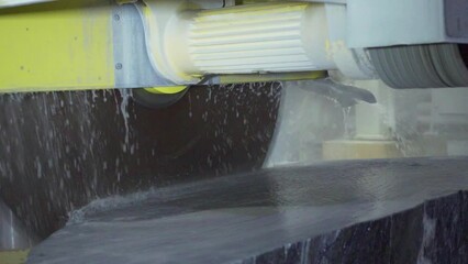 marble cutting factory, marble being cooled with water while cut - industrial