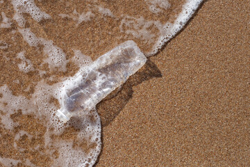 Fototapeta na wymiar Plastic bottle on the beach