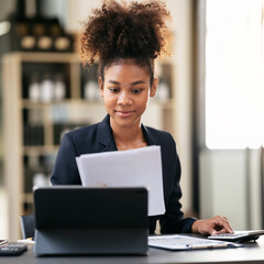 African american businesswoman in suit reading accounting inform