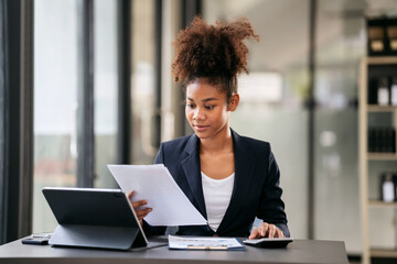 African american businesswoman in suit reading accounting inform