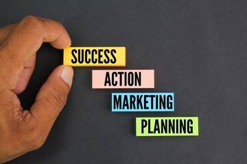 colored paper arranged in a ladder with the words Planning Marketing Action Success. concept for...