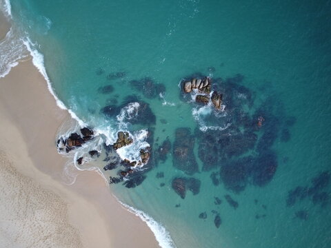 a drone phoro of huatulco oaxaca mexico of the beach with rocks and cliffs waves in summer spring vation point in latinamerica