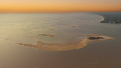 Sunset sky scene with a tropical Summer with wave water as white sand beach  in the lagoon background