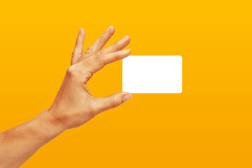 Woman hand showing credit card, or card, or business card or voucher, isolated on orange yellow...