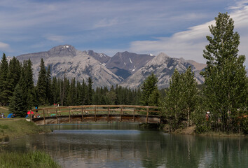 Mountain landscape with lake and wooden bridge. Recreation zone. Banff National Park, Alberta, Canada
