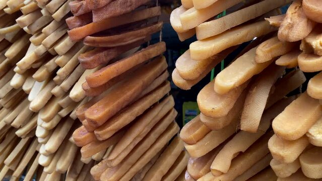 Rows and rows of Chhurpi yak cheese hanging at a local market in Ilam, Nepal.