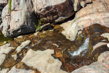 A spring flows from the Gneiss Rocks and formaations in the Texas Hill Country