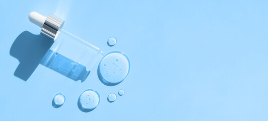 pipette drop of serum test on a blue background sun glare