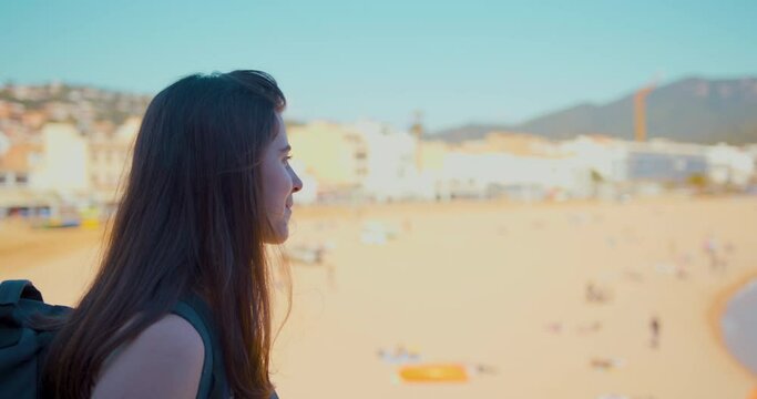 Young girl looking at the sea landscape