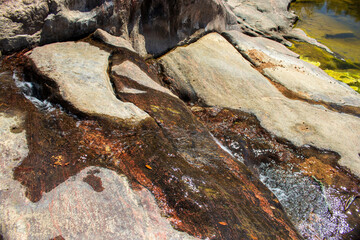 Water flows over the Gneiss Rocks and Boulders - Inks Lake State Park Texas