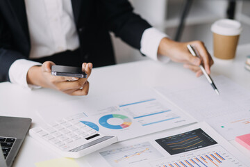 Financial analysts analyze business financial reports on a digital tablet planning investment project during a discussion at a meeting of corporate showing the results of their successful teamwork.