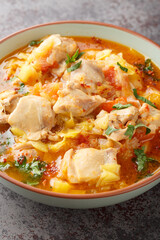 Bhutanese spicy chicken stew jasha maroo closeup on the bowl on the table. Vertical