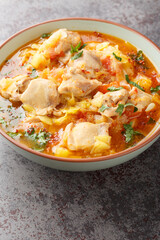 Slow cooked Bhutanese Spicy Chicken Stew Jasha Maroo closeup on the bowl on the table. Vertical