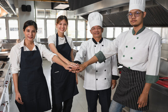 Join hand team Asia chef at big kitchen