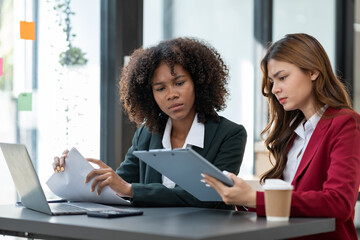 Young Asian and African businesswoman Africans brainstorming on real estate projects. investment plan Financial business together in the office management concept management.