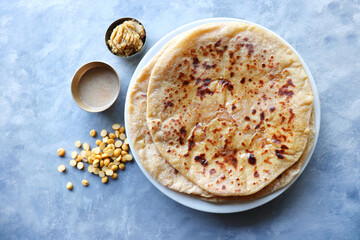 Puran Poli is an Indian sweet flatbread stuffed with chana dal, jaggery, ghee and cardamom and is usually eaten at Holi or Gudi Padva festival. Recipe ingredients. copy space. Healthy sweet dessert. 