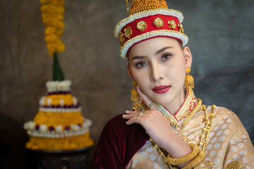 Pretty young Asian woman dressed elegantly in dress Luang Prabang Laos style for the Songkran...