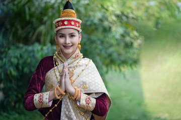 Pretty young Asian woman dressed elegantly in dress Luang Prabang Laos style for the Songkran Festival is the national tradition of Thailand and in Vientiane Laos at Chiang Mai Thailand.